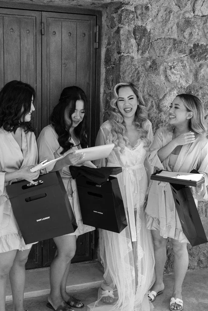 Bride and bridesmaids open their gifts