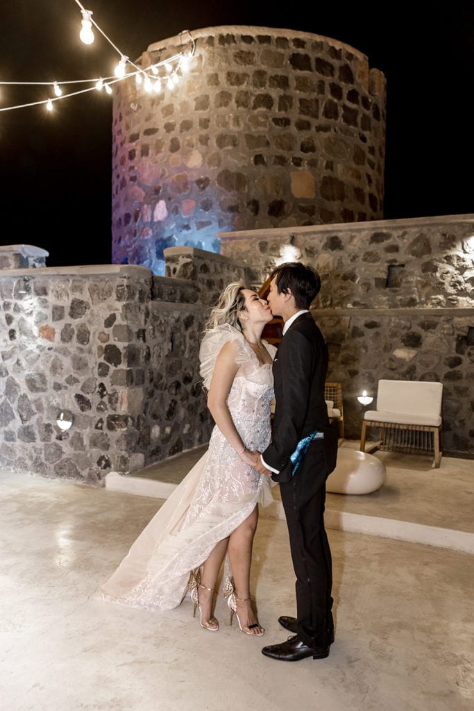 Bride and groom kiss during Cavo Ventus wedding reception