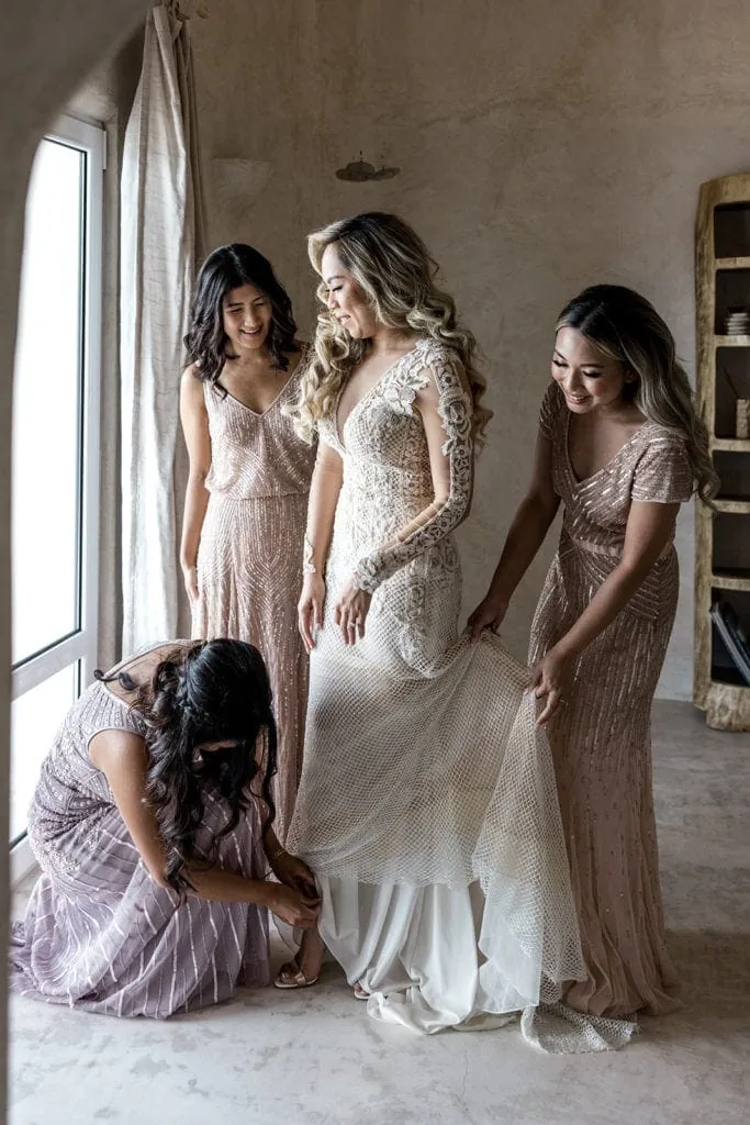 Bridesmaids help bride get ready