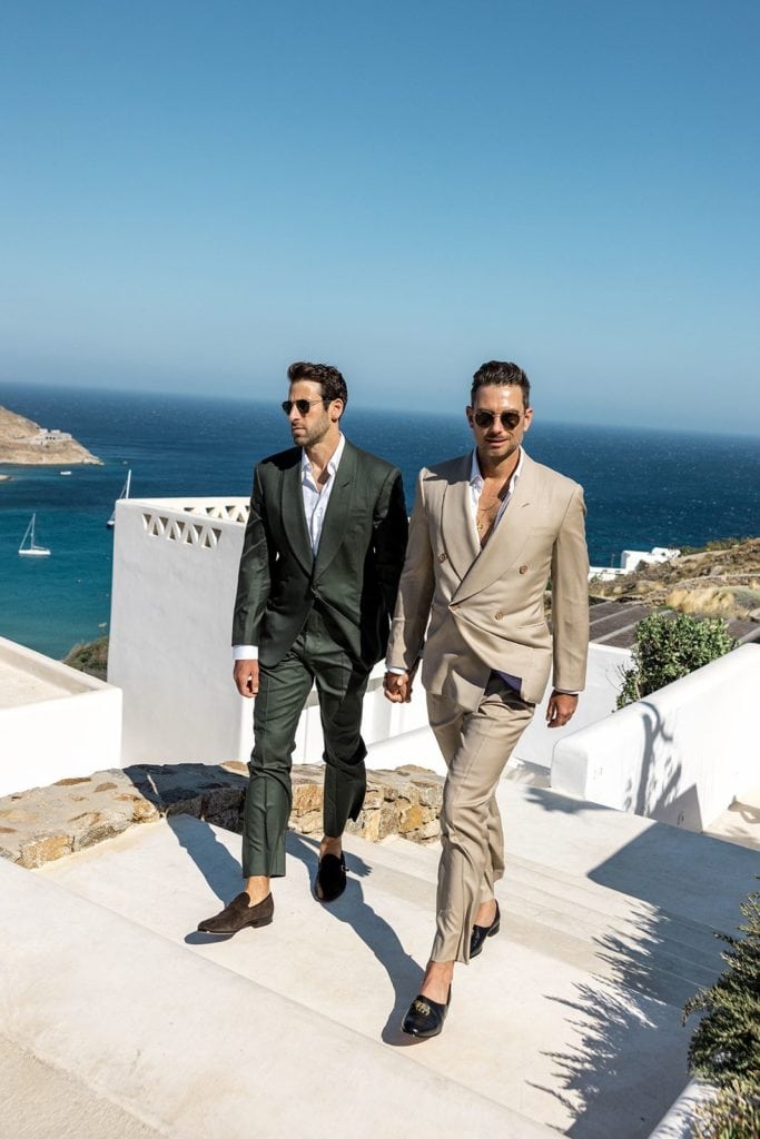 Grooms walk together to Mykonos wedding ceremony
