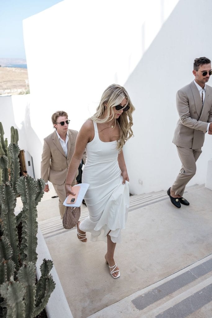 Woman and men walking up stairs to the Mykonos wedding ceremony