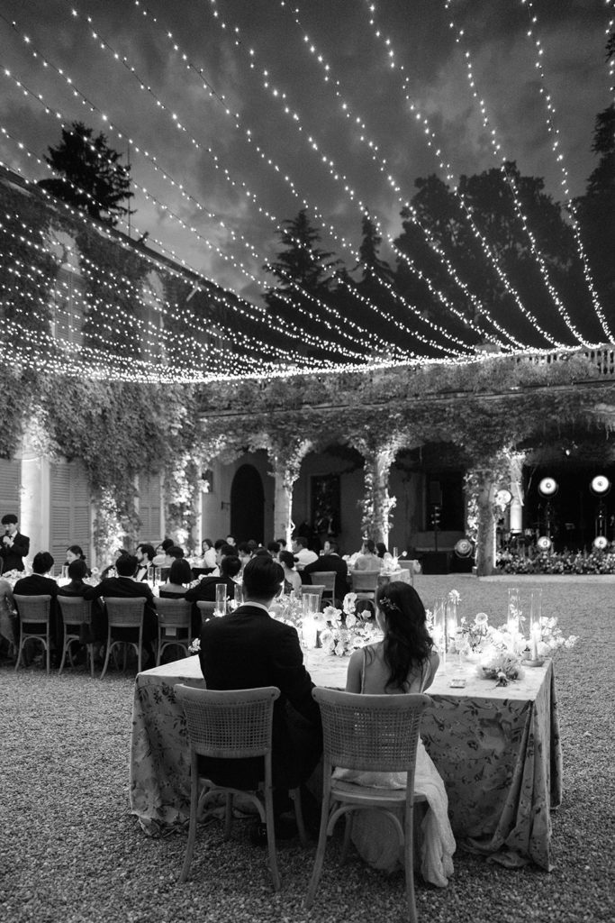 Bride and groom at intimate sweetheart table during wedding reception