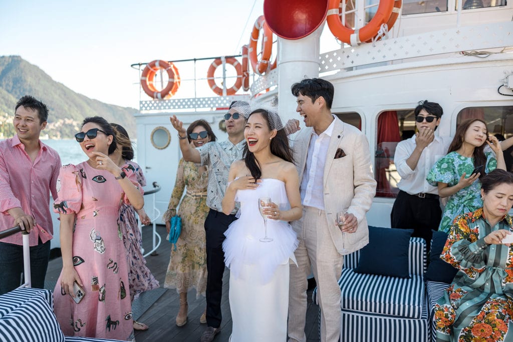 Bride and groom together on Lake Como ferry boat during wedding party