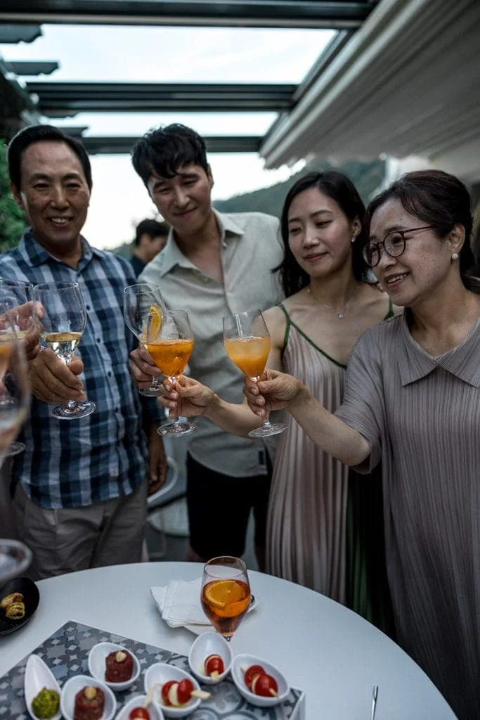 Guests toast during wedding welcome party