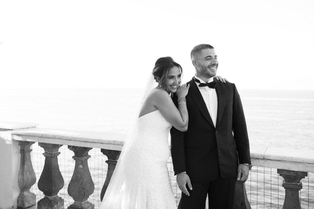 Bride and groom black and white portrait on Villa Astor balcony