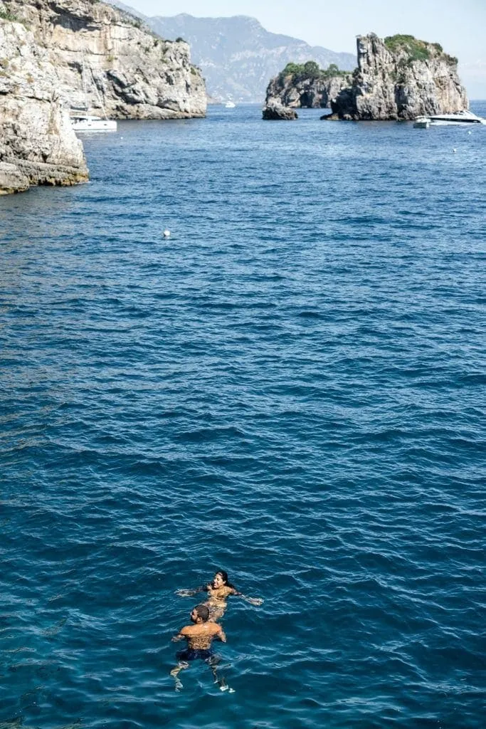Bride and groom swimming in Amalfi Coast