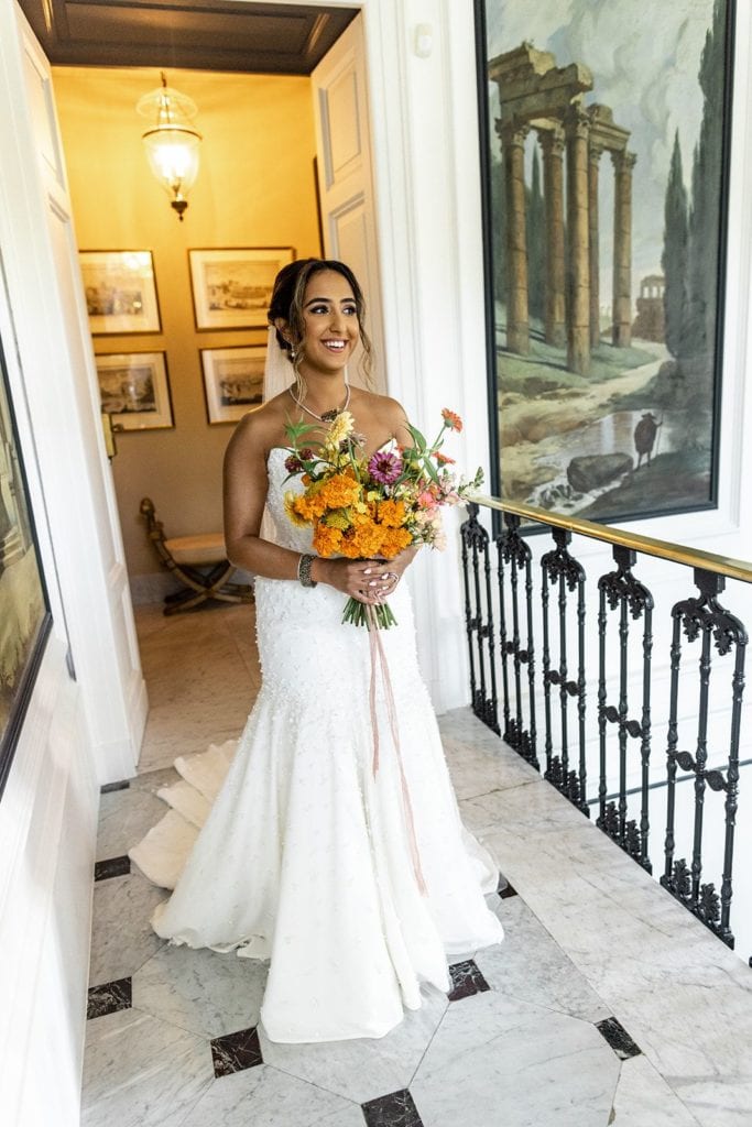 Bride holding orange bouquet at Villa Astor in Sorrento, Italy