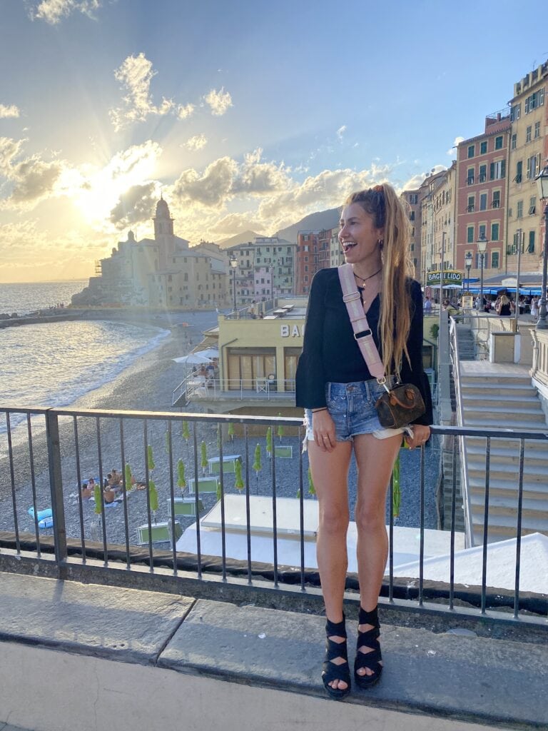 Lilly Red poses in front of Portofino, Italy as a local travel guide