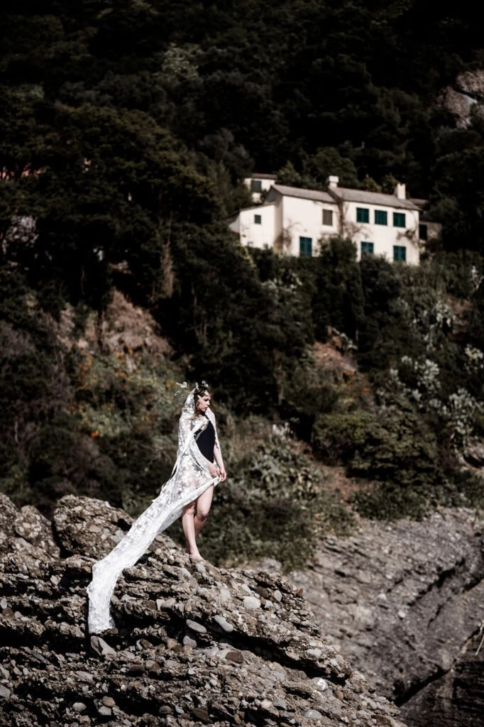Model stands in Punta Chiappa, Italy for bridal inspiration