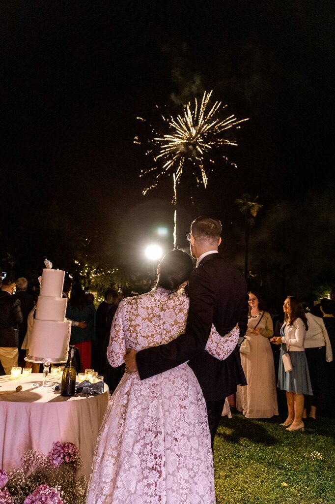 Bride and groom watching fireworks during Tuscany italy wedding