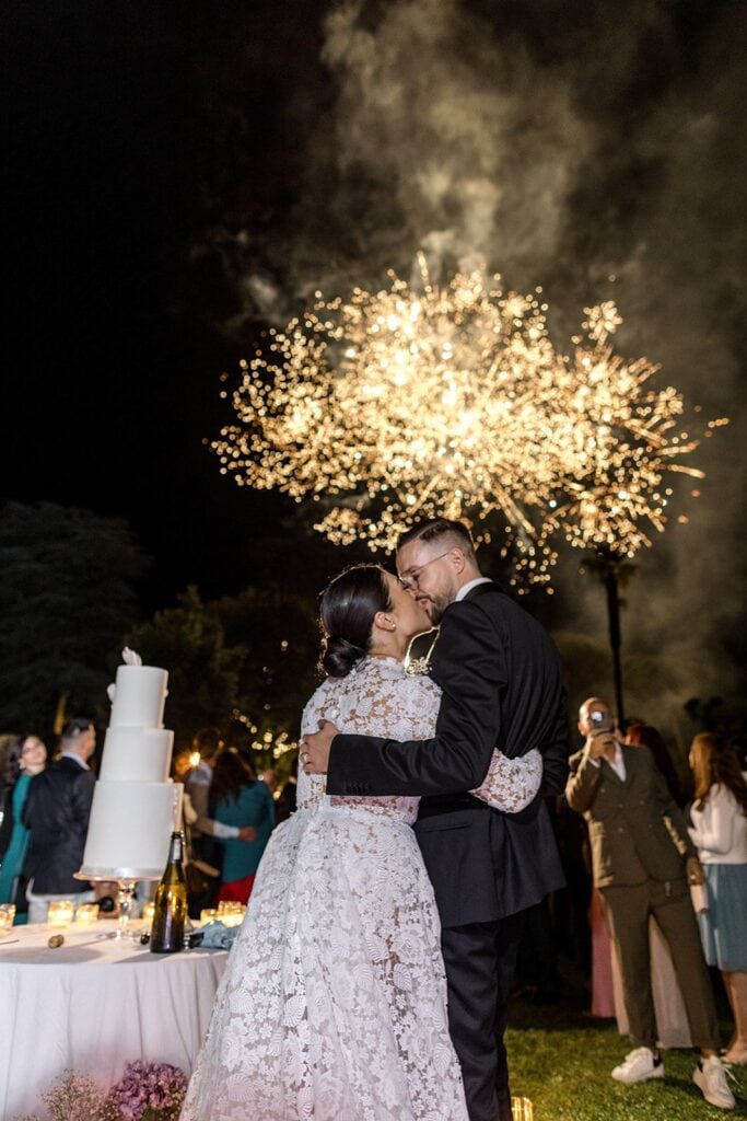 Bride and groom watching fireworks during Tuscany wedding
