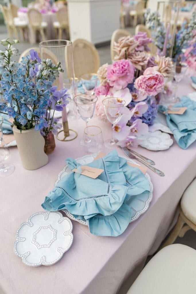 Bright blue and pink wedding reception tablescape design