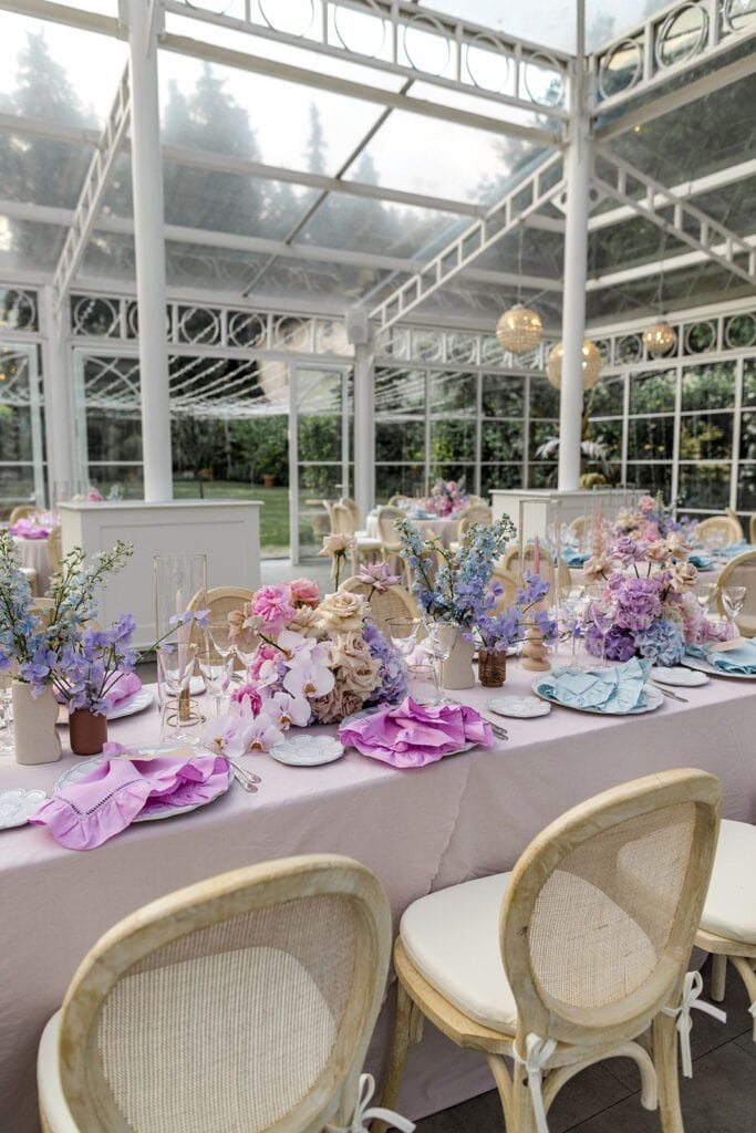Pink and purple wedding reception table setting