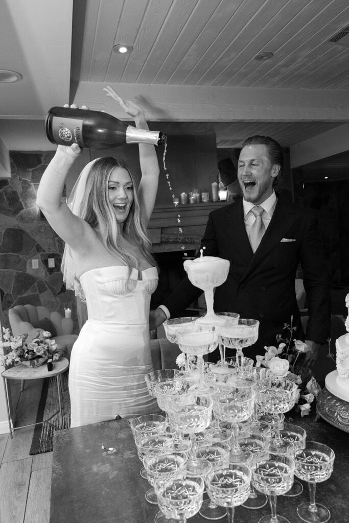 Bride pours champagne tower