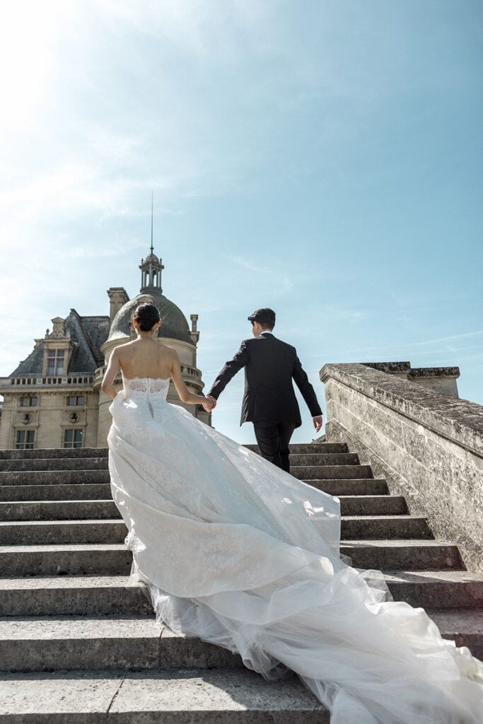 Bride and groom portrait on staircase at Chateau de Chantilly