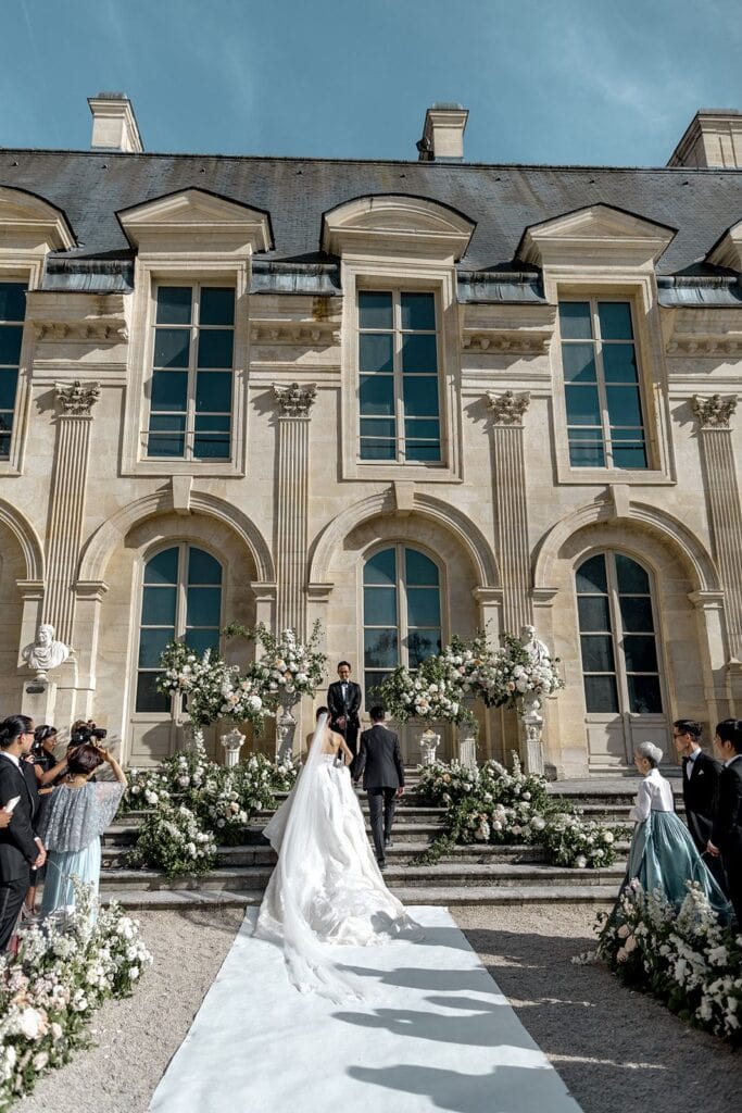 Bride and groom at wedding ceremony altar at Chateau de Chantilly