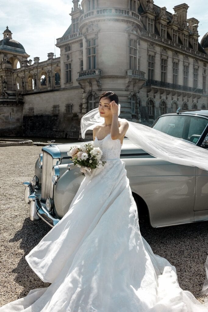 Bride portrait with vintage Rolls Royce at Chateau de Chantilly