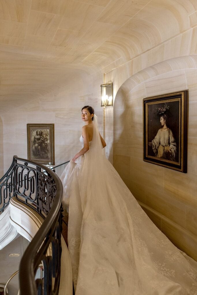 Bride walking down staircase for first look