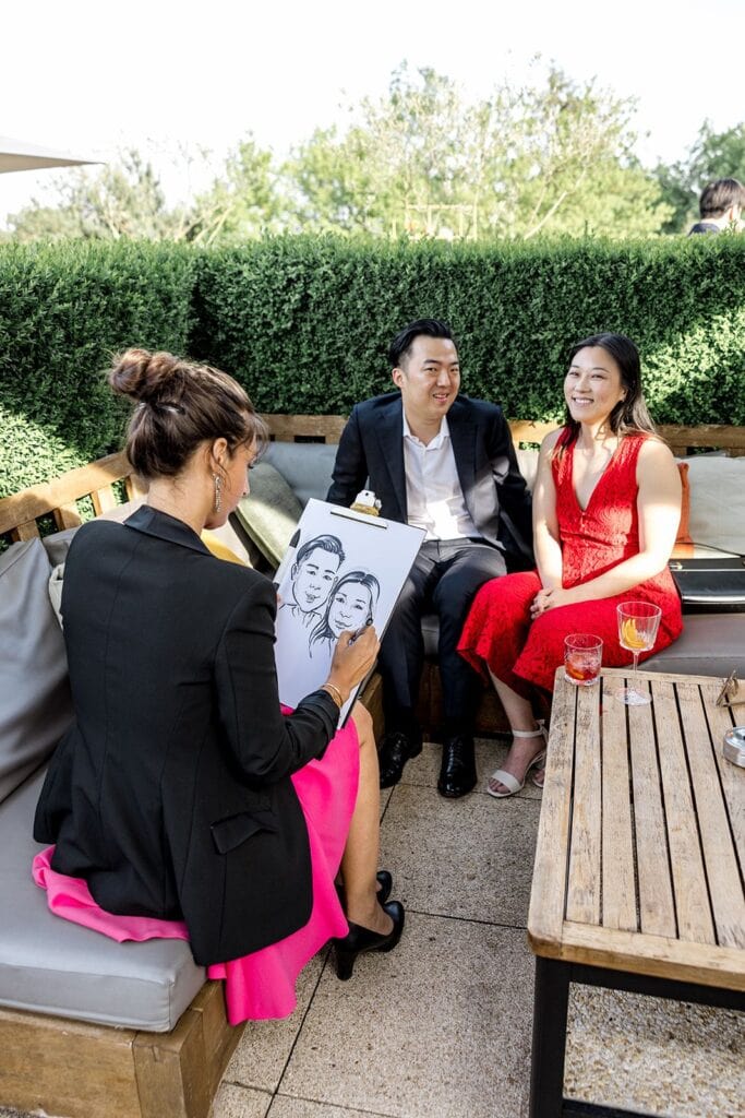 Charicaturist paints pictures of guests at France destination wedding welcome party