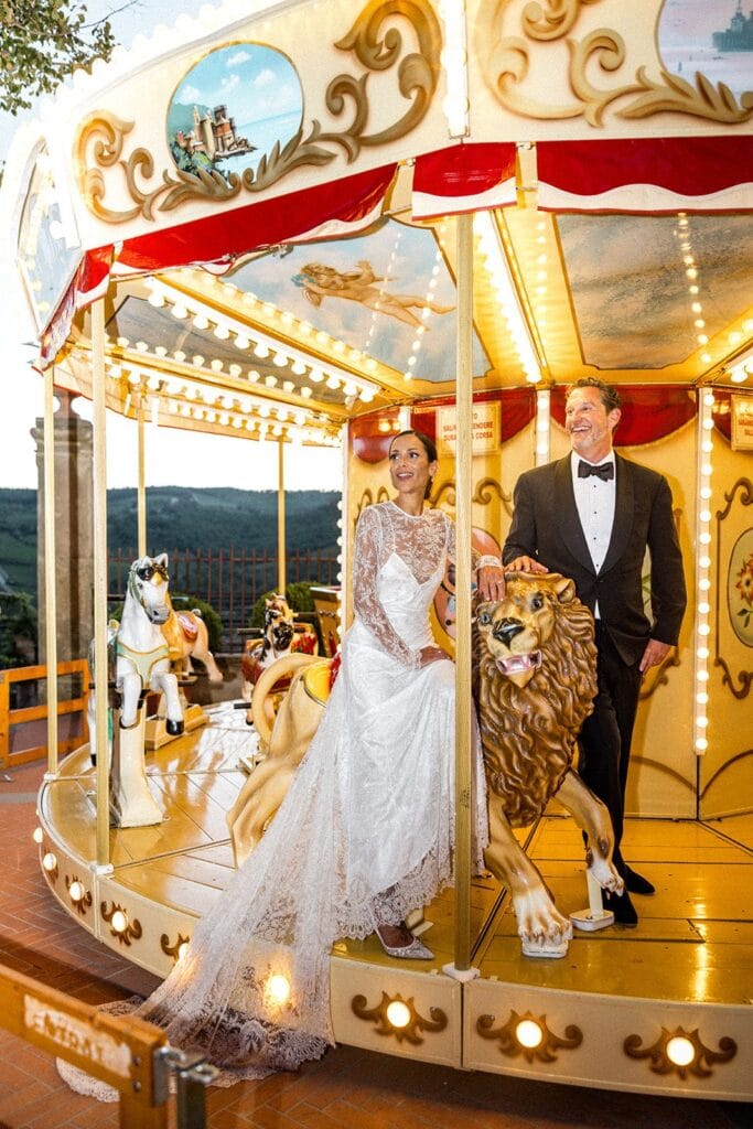 Bride and groom on carousel at wedding reception
