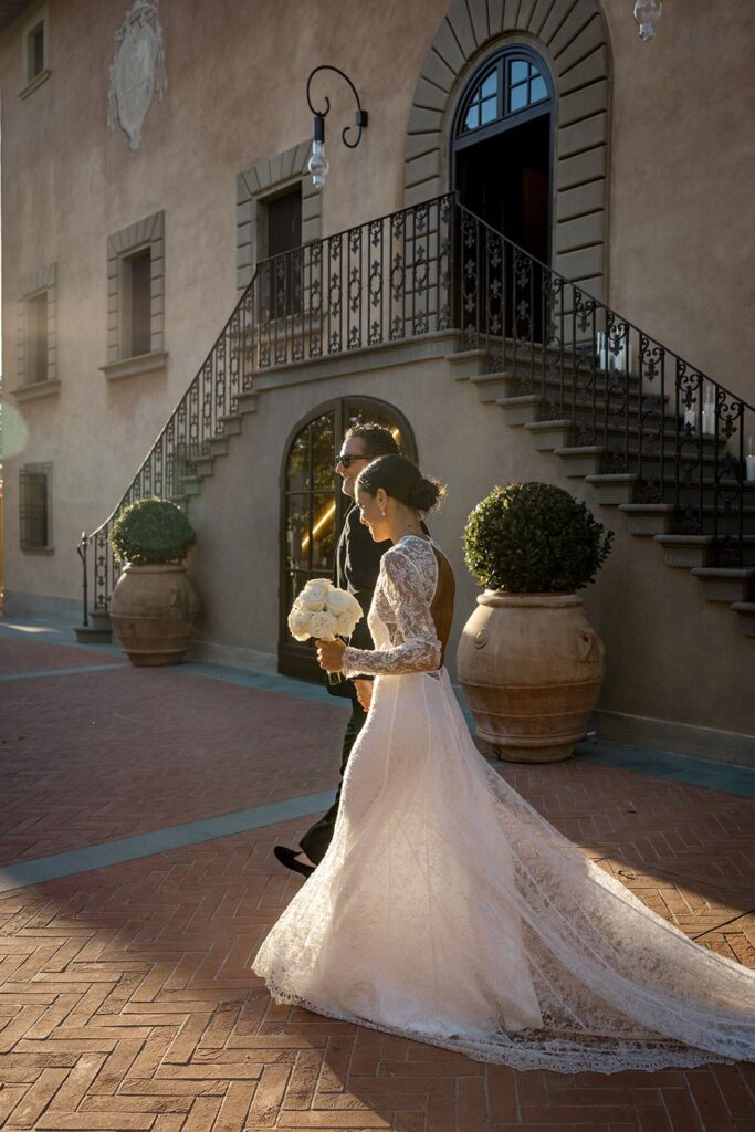 Bride and groom exiting Tuscany vineyard wedding venue