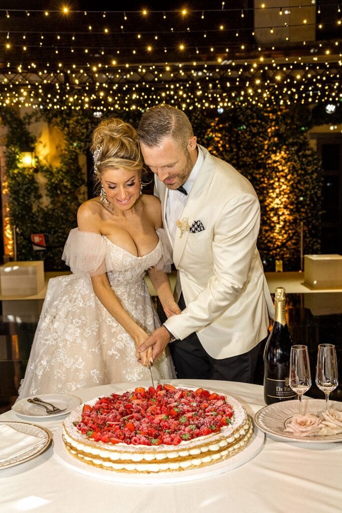 Bride and groom cutting Italian wedding cake