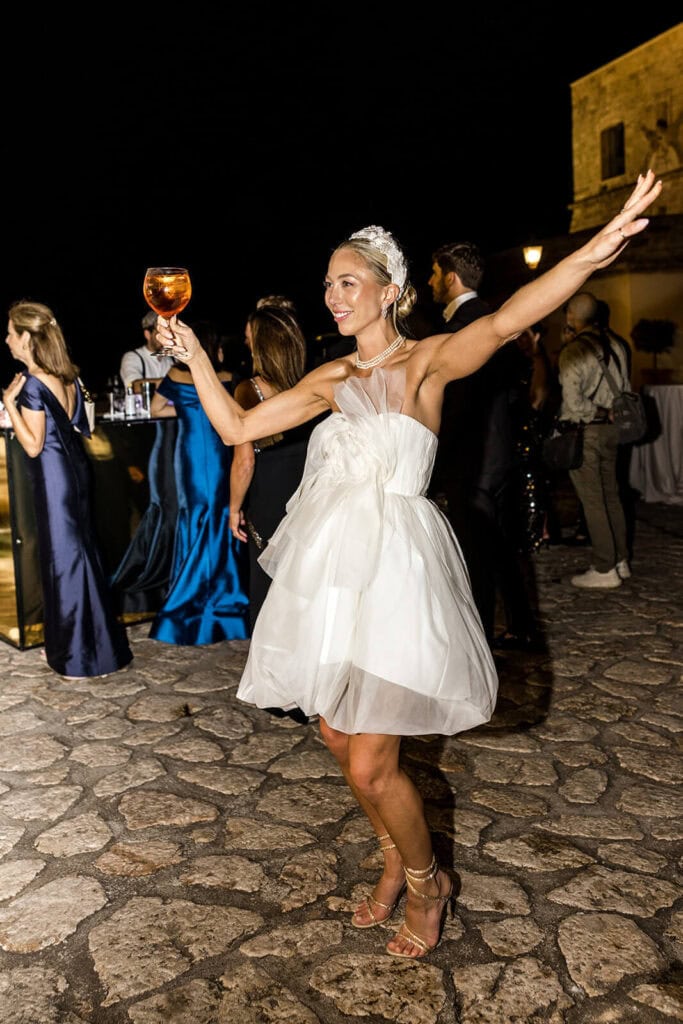 Bride wearing short Danielle Frankel dress for wedding party, photographed by Lilly Red