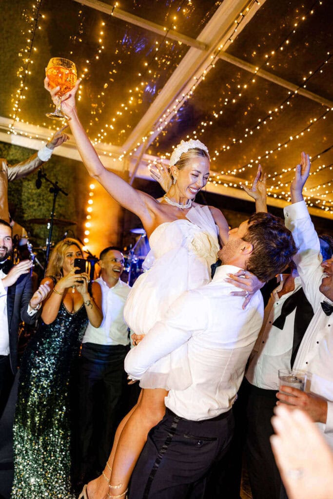 Groom lifting bride on the dancefloor, photographed by Lilly Red